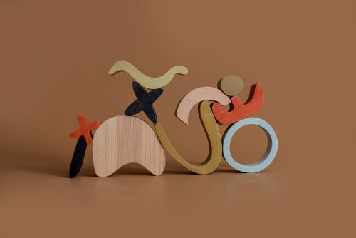 Wooden abstract art building blocks in earthy colors. Curved, minimal, with modern lines.