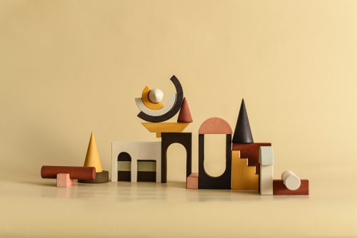 Wooden architectural building blocks in earthy colors. Curved, minimal, with modern lines.